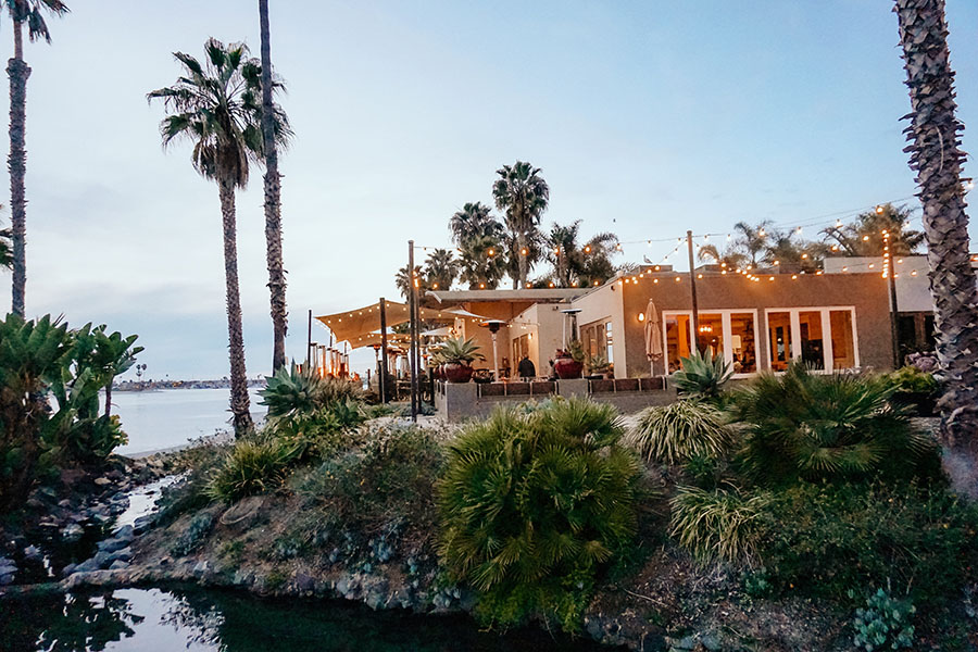 Exterior view of restaurant at the edge of the bay with rocky landscape