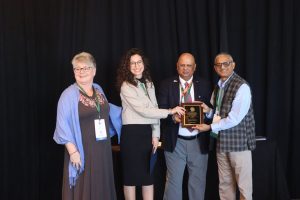 Photo of Andreaa Rilakovic receiving an IPM Achievement Award at the 2025 event.