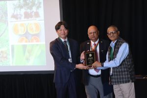 Individual receiving an award at academic conference.