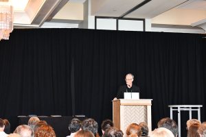 A person standing behind a podium.