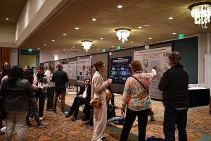 Conference attendees at an academic poster session.